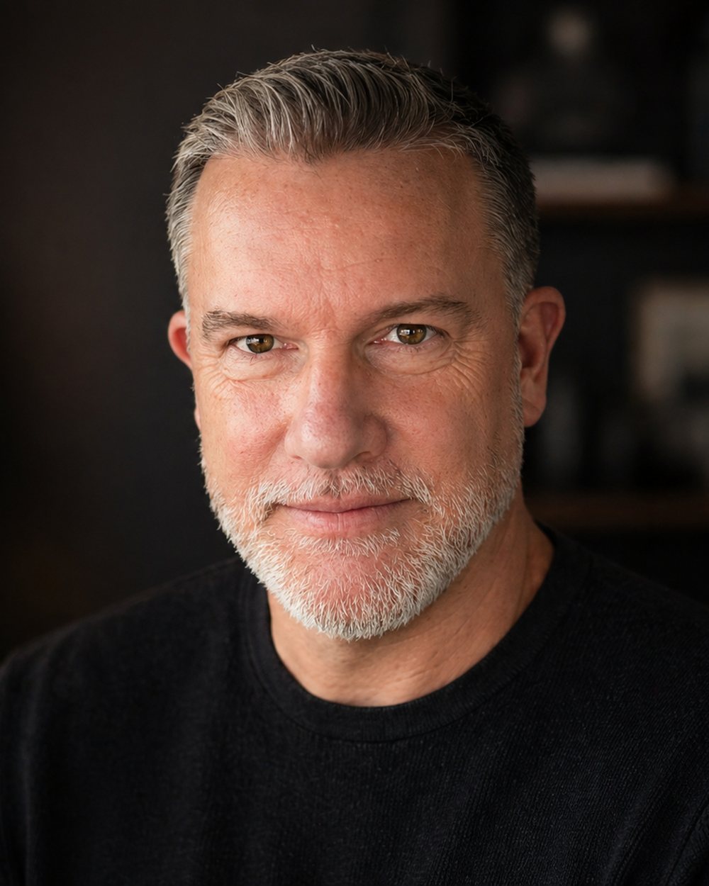 James Pratt, head and shoulders, in front of a bookshelf